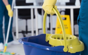 Cleaning employee holding a bucket to clean floors